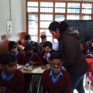 Venerate welfare Foundation's Volunteer handover the snacks to kids